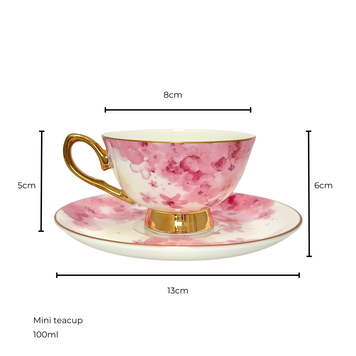White and pink flower teacup with gold handle and edges sitting on matching white and pink flower saucer. Isolated on a white background. Measurements shown of 8cm teacup diameter and 5cm height, saucer diameter 13cm and 6cm height of saucer and teacup