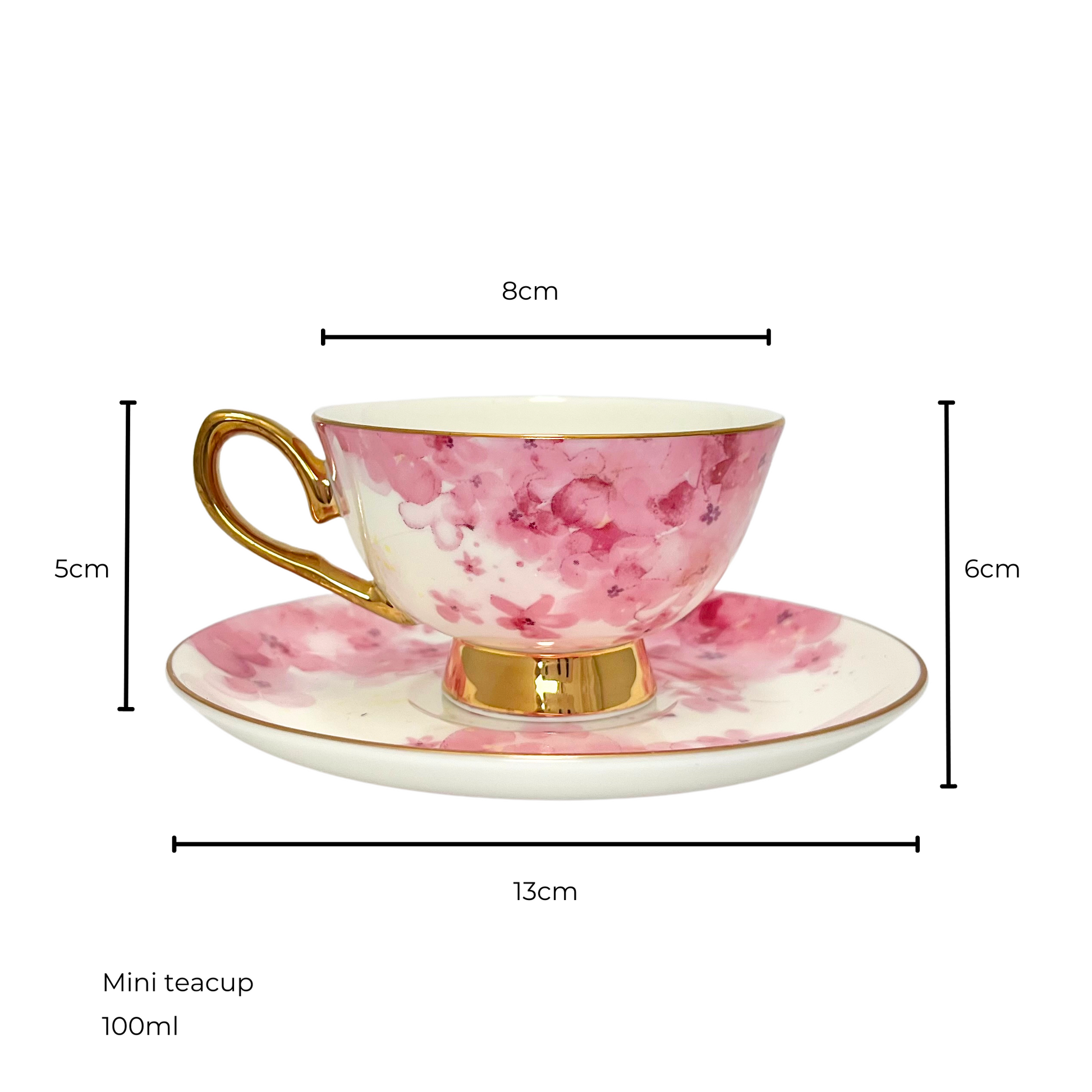 White and pink flower teacup with gold handle and edges sitting on matching white and pink flower saucer.  Isolated on a white background. Measurements shown of 8cm teacup diameter and 5cm height, saucer diameter 13cm and 6cm height of saucer and teacup