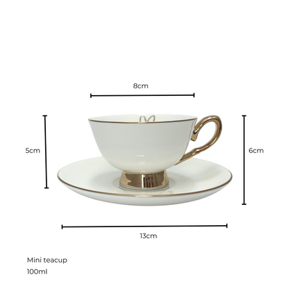 White teacup with gold handle and edges sitting on matching white and gold saucer.  Isolated on a white background. Measurements shown of 8cm teacup diameter and 5cm height, saucer diameter 13cm and 6cm height of saucer and teacup