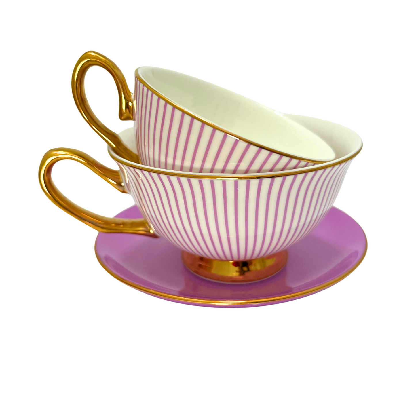 Two teacups with purple and white stripes and gold handle and edges.  Mini teacup stacked inside standard sized teacup.  Sitting on matching purple saucer.  Isolated on a white background. 